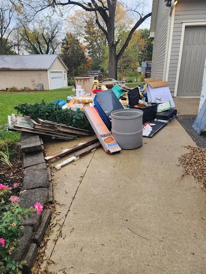 Dumpster being loaded with debris for Estate Cleanout Dumpster Rental in Metamora